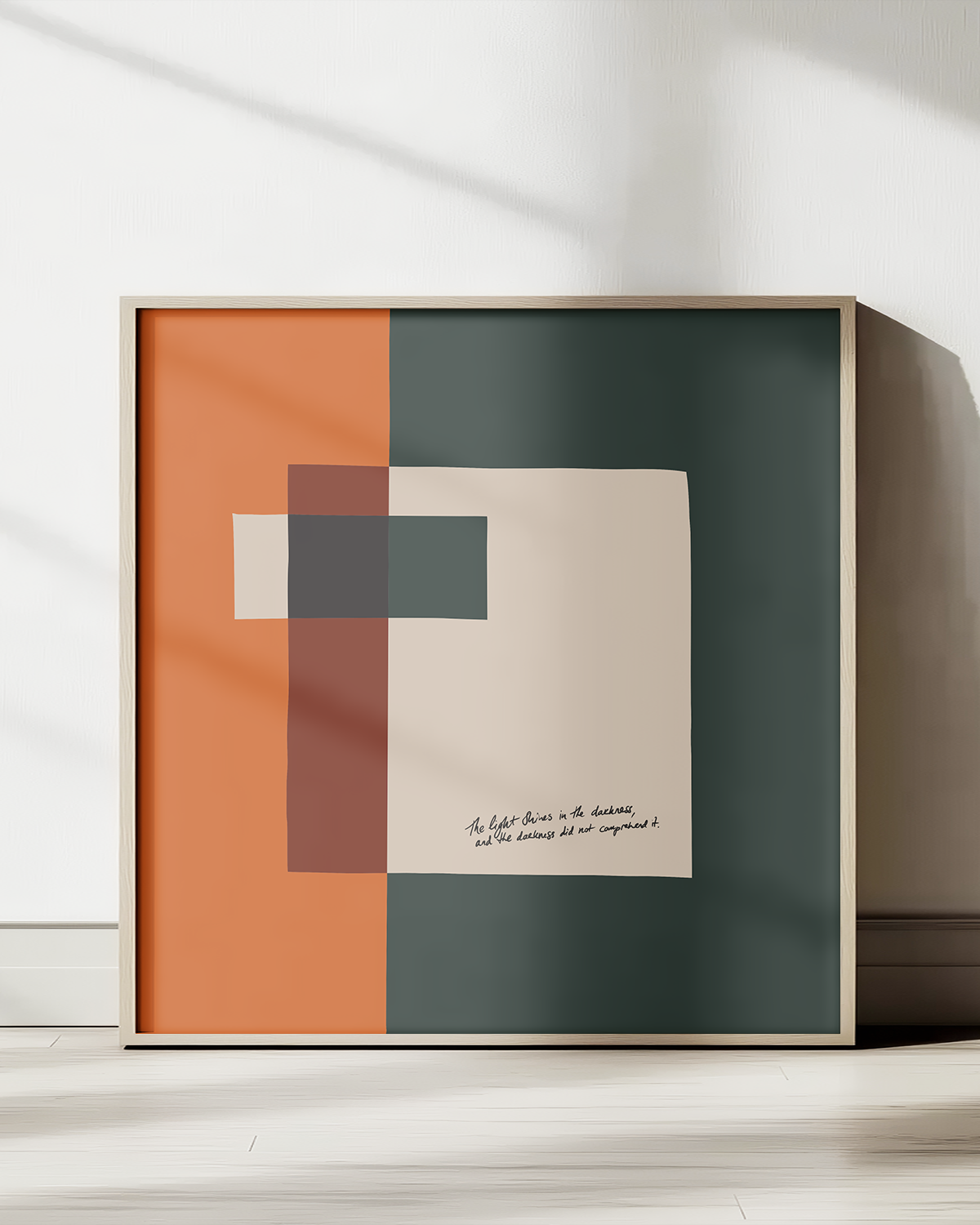 Framed abstract art print with geometric shapes on a white wall.